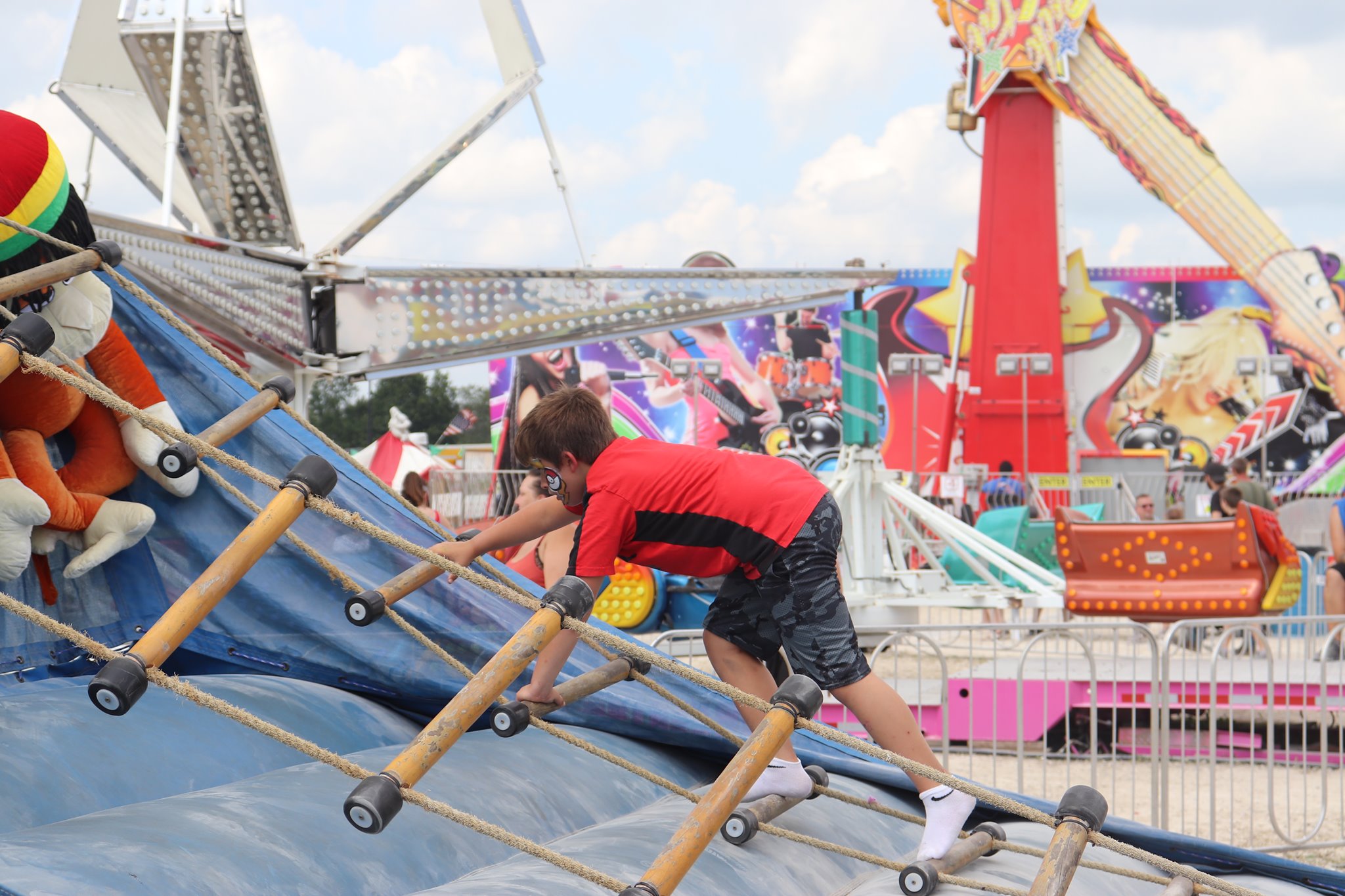 Kid climbs attraction at the Washington County Fair