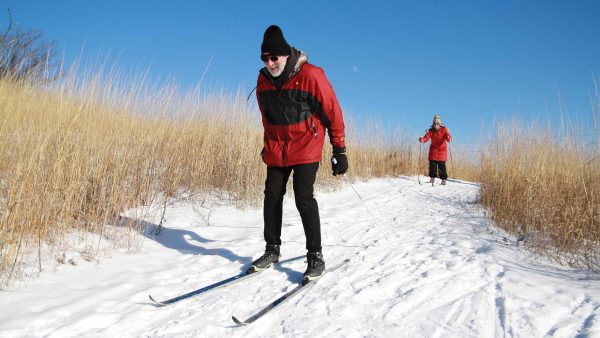 Couple cross-country skiing on the trails in West Bend